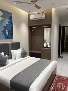 a bedroom with a large bed and a mirror at Hotel route 54 in Bathinda