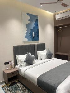 a bedroom with a large bed with white pillows at Hotel route 54 in Bathinda +6 photos