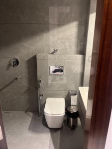 a bathroom with a white toilet and a sink at Hotel route 54 in Bathinda