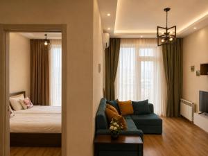 a living room with a bed and a couch at Vazi Aparthotel in Tbilisi City