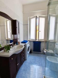 a bathroom with a sink and a washing machine at Dimora al Civico 35 in Montefano +12 photos