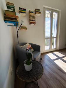 a living room with a couch and a table with a plant at Dimora al Civico 35 in Montefano
