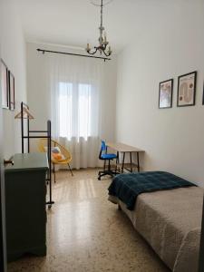 a bedroom with a bed and a desk and a table at Dimora al Civico 35 in Montefano