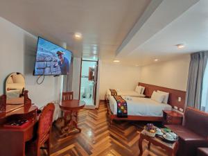 a hotel room with a bed and a tv at Kantu hotel in Cusco