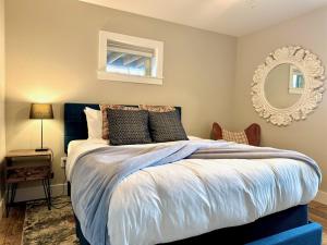a bedroom with a large bed and a mirror at Charming 1 bedbath Suite in waterfront Cottage in Somers