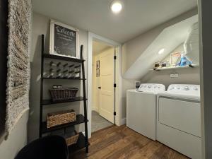 a small laundry room with a washer and dryer at Charming 1 bedbath Suite in waterfront Cottage in Somers