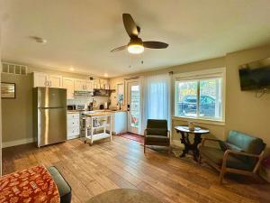 a kitchen with a refrigerator and a table and chairs at Charming 1 bedbath Suite in waterfront Cottage in Somers