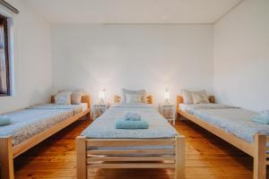 a room with two beds and two tables at Kuća Mitića in Pirot