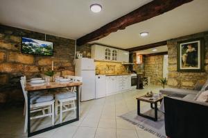 a kitchen and living room with a table and refrigerator at Kuća Mitića in Pirot
