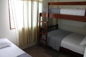 a bedroom with two bunk beds and a window at Hotel Estación del Sol in Las Núñez