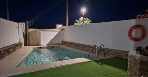 a swimming pool in a backyard at night at El Antiguo Corral de Sevilla in Navalcán