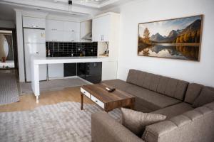 a living room with a couch and a table at Kemer Suit Residence in Kemer
