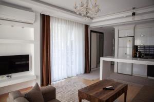 a living room with a couch and a coffee table at Kemer Suit Residence in Kemer