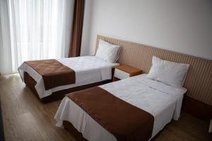 a hotel room with two beds and a window at Kemer Suit Residence in Kemer +20 photos