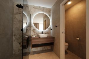 a bathroom with a sink and a mirror at Nono Ban Boutique Hotel & Villas in Gornji Humac +187 photos