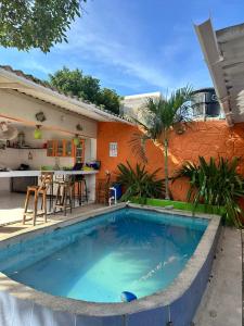 a large swimming pool in front of a house at Hotel Taganga Dive Santa Marta in Taganga