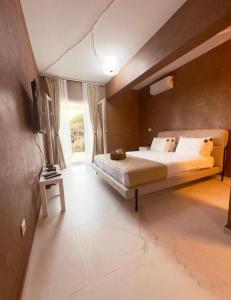 a large bedroom with a large bed and a tv at Mostoliva Sea View Studios in Pržno +50 photos