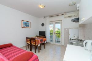 a living room with a couch and a table at Apartments Verdea in Kampor