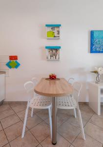 a table and chairs in a room with paintings at Apartments Lea in Mandre +45 photos
