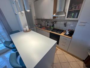 a kitchen with a white counter and a white refrigerator at Casa di Minù in Empoli