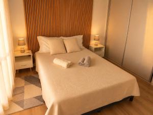 a bedroom with a bed with two towels on it at Douro Garden in Resende +18 photos