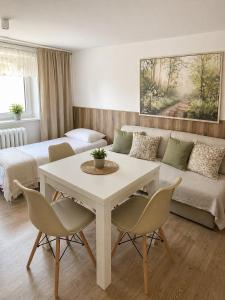 a living room with a table and a couch at A+R Pension in Pilsen