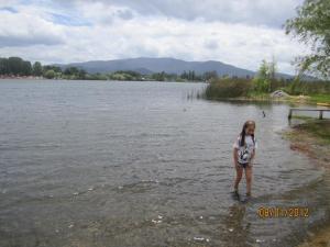 a little girl standing in the water at Mi Paraiso in Quillón