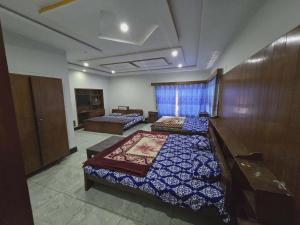 a room with two beds in a room at Nice Guest House GPO Murree in Murree