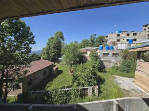 a view of the yard from the balcony of a building at Nice Guest House GPO Murree in Murree