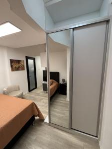 a bedroom with a sliding glass door with a bed at Montevideo Centro in Montevideo