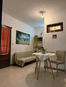 a living room with a couch and a table at Garden! in Villa Ballester +3 photos