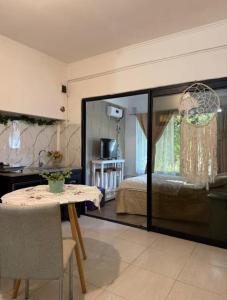 a living room with a table and a bed at Garden! in Villa Ballester