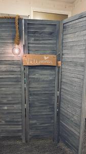 a pair of gates with a sign on them at Bollnäs Lugn och Ro in Bollnäs +6 photos