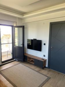 a living room with a flat screen tv on a wall at Duplex Villa with Panoramic Sea View in Gokceada Town