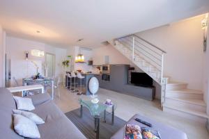 a living room with a couch and a staircase at Como Lake Modern Apartament Ulivi in Mezzegra