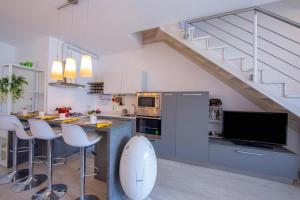 a kitchen with a kitchen island with a counter top at Como Lake Modern Apartament Ulivi in Mezzegra