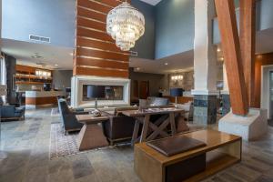 a lobby of a hotel with a chandelier at Sutton Place Hotel Revelstoke Mountain Resort in Revelstoke