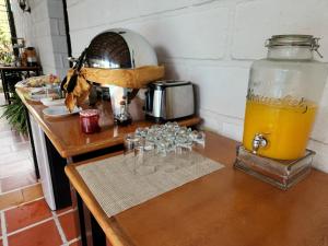 a table with glasses and a jar of orange juice at Park Place Hotel in Siguatepeque
