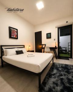 a bedroom with a large white bed and a table at Habitara - Carancho in Atasta de Serra +15 photos