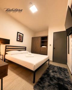 a bedroom with a large bed in a room at Habitara - Carancho in Atasta de Serra
