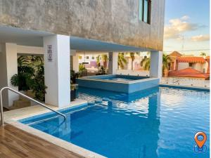 a swimming pool in the middle of a villa at Depa Amplio Vista al Mar Cerca del Malecón in Mazatlán