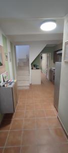 a kitchen with a tile floor and stairs in a room at Mazzmarill in Pizzoferrato