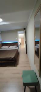 a room with two beds and a green bench in it at Mazzmarill in Pizzoferrato