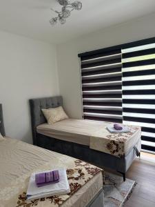 a bedroom with two beds and a window at Forest View Villa in Ilijaš +8 photos
