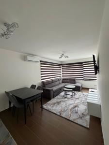 a living room with a couch and a table at Forest View Villa in Ilijaš