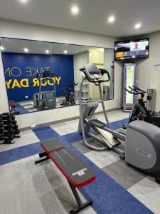 a gym with a treadmill and ellipticals in a room at Comfort Inn & Suites Harvey - Chicago Southland in Harvey