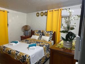 a bedroom with two beds and a vase of flowers at Bleu Ocean in Deshaies