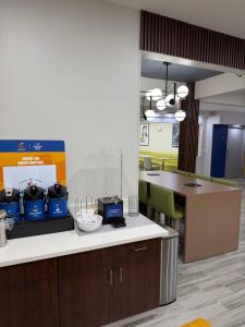 an office with a kitchen with a counter and chairs at Comfort Inn & Suites Harvey - Chicago Southland in Harvey