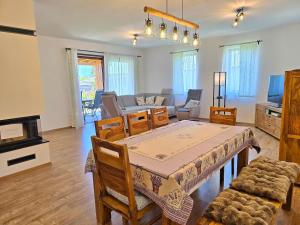 a living room with a table and chairs and a couch at no 117 Villa Balantis in Vonyarcvashegy