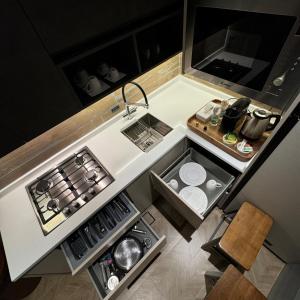 an overhead view of a small kitchen with a sink at The Elegance Rooms in Nizwa +16 photos